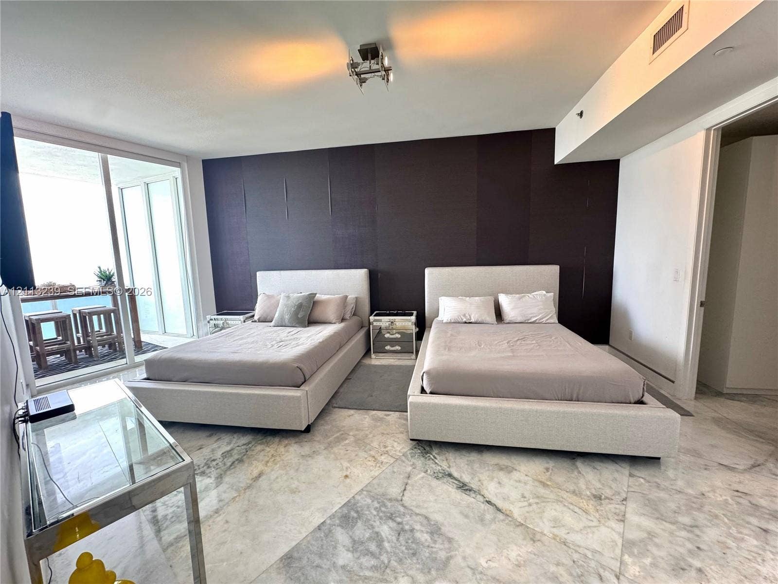 16001 Collins Avenue, #2403, Sunny Isles Beach, Sunny Isles Beach, FL 33160 Large-format stone tile flooring, accent wall, and sliding glass balcony doors