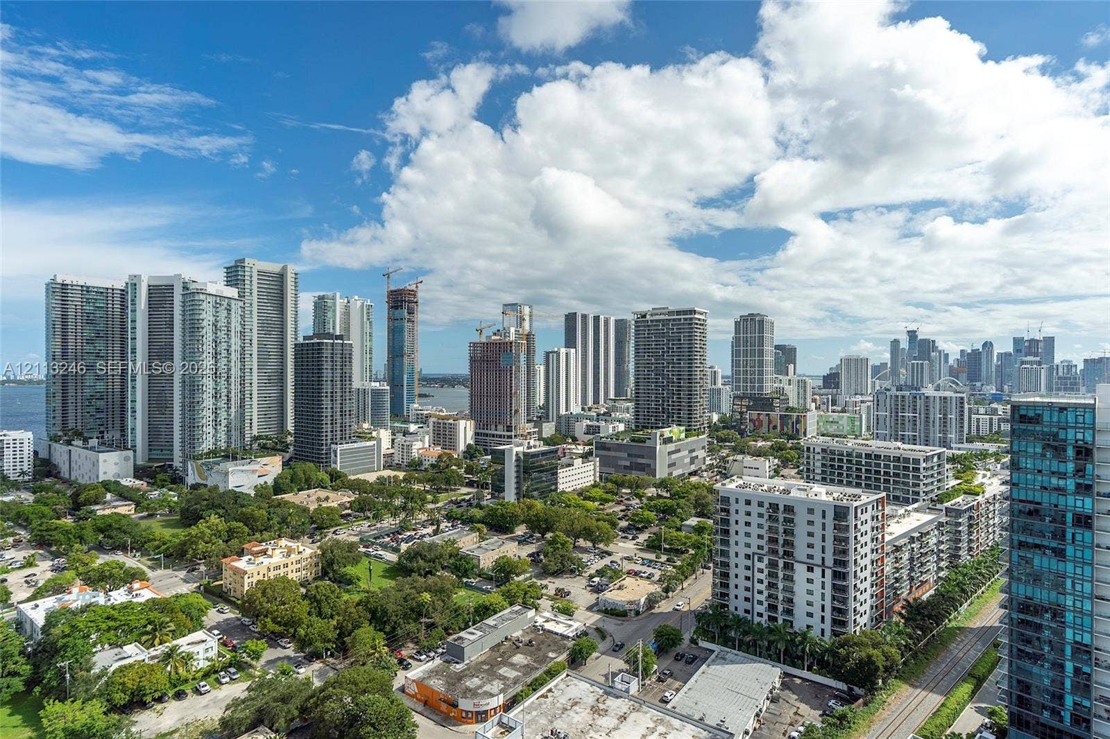 121 NE 34th Street, #2703, Miami, FL 33137 Elevated urban perspective featuring high-rise architecture, glass-clad building facades, and metropolitan skyline scenery