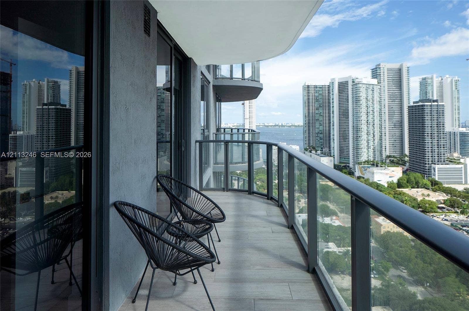 121 NE 34th Street, #2703, Miami, FL 33137 Covered balcony featuring tile flooring and glass panel railings with metal framing
