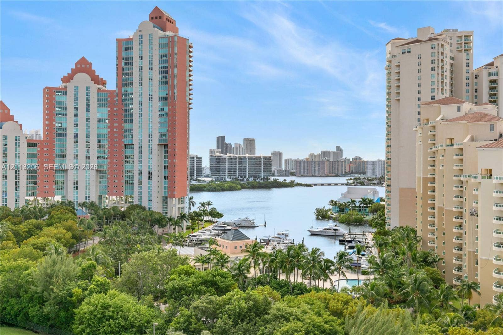 3300 NE 191st Street, #1514, Aventura, FL 33180 Panoramic views of marina, ocean and bay waters, and a distant cityscape featuring mature tropical landscaping