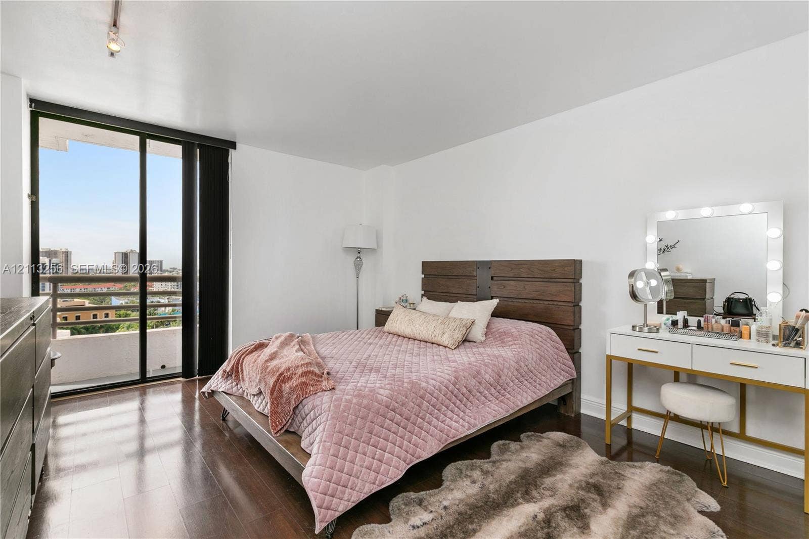 3300 NE 191st Street, #1514, Aventura, FL 33180 Wood-finish flooring, floor-to-ceiling sliding glass doors, and a private balcony