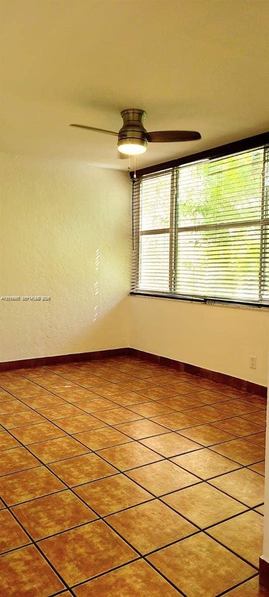 9410 Live Oak Place, #109, Davie, Davie, FL 33324 Large-format tile flooring, multi-pane windows, and a ceiling fan with integrated lighting