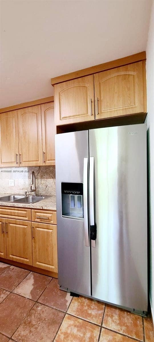 9410 Live Oak Place, #109, Davie, Davie, FL 33324 Kitchen area featuring light-finish cabinetry, stone-surface countertops, stainless steel side-by-side refrigerator, dual-basin stainless steel sink with high-arc faucet, and tiled flooring
