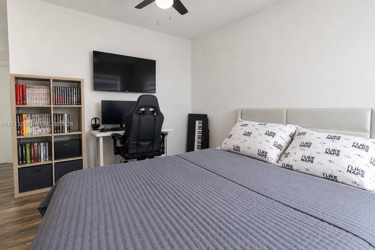 11494 NW 79th Lane, Doral, FL 33178 Wood-finish flooring, neutral walls, and a ceiling fan with integrated lighting