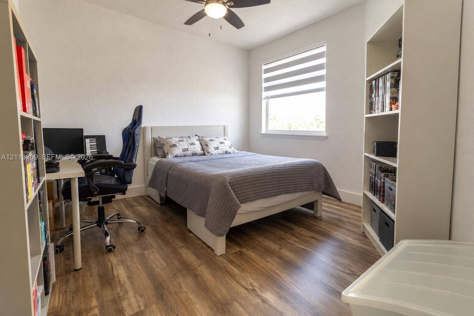 11494 NW 79th Lane, Doral, FL 33178 Room featuring wood-finish flooring, a ceiling fan with integrated lighting, and a window with dual-layer shade
