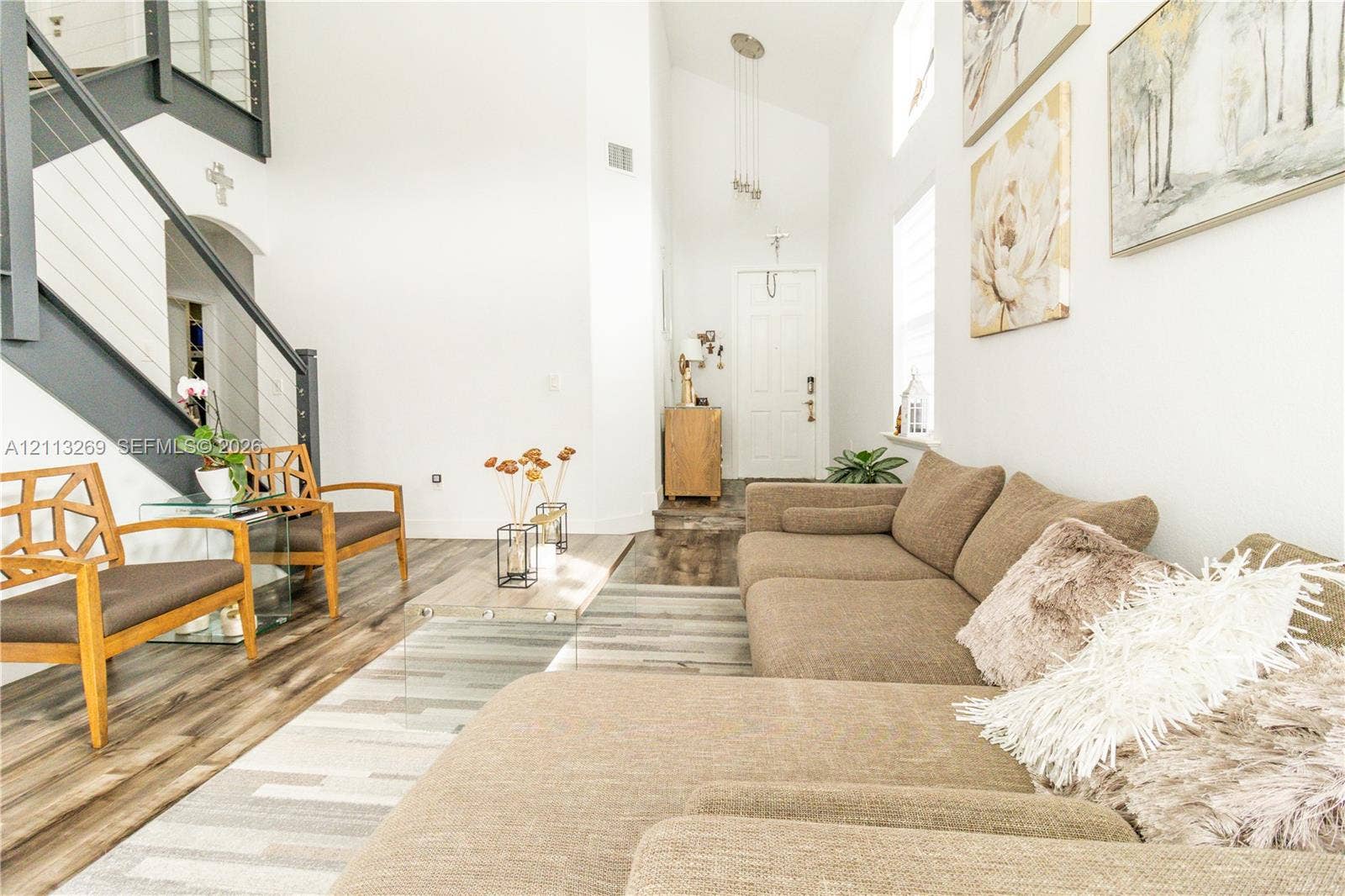 11494 NW 79th Lane, Doral, FL 33178 Vaulted ceilings, staircase with cable railing, wood-finish flooring, and multi-pane front door