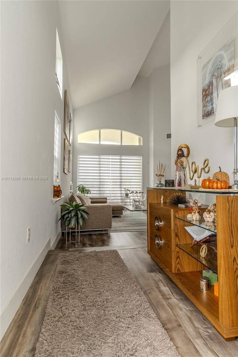 11494 NW 79th Lane, Doral, FL 33178 Vaulted ceilings, wood-finish flooring, and an arched transom window
