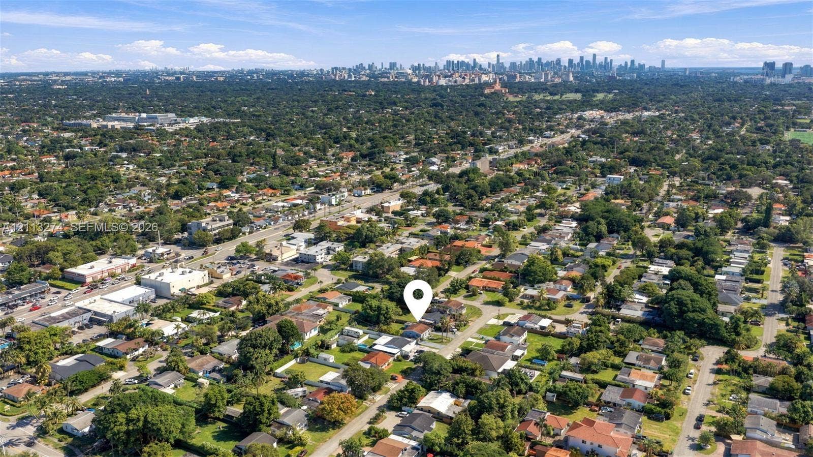 6521 SW 42nd Street, Miami, FL 33155 Aerial perspective of the property location featuring mature tree canopy, established neighborhood grid, and distant urban skyline