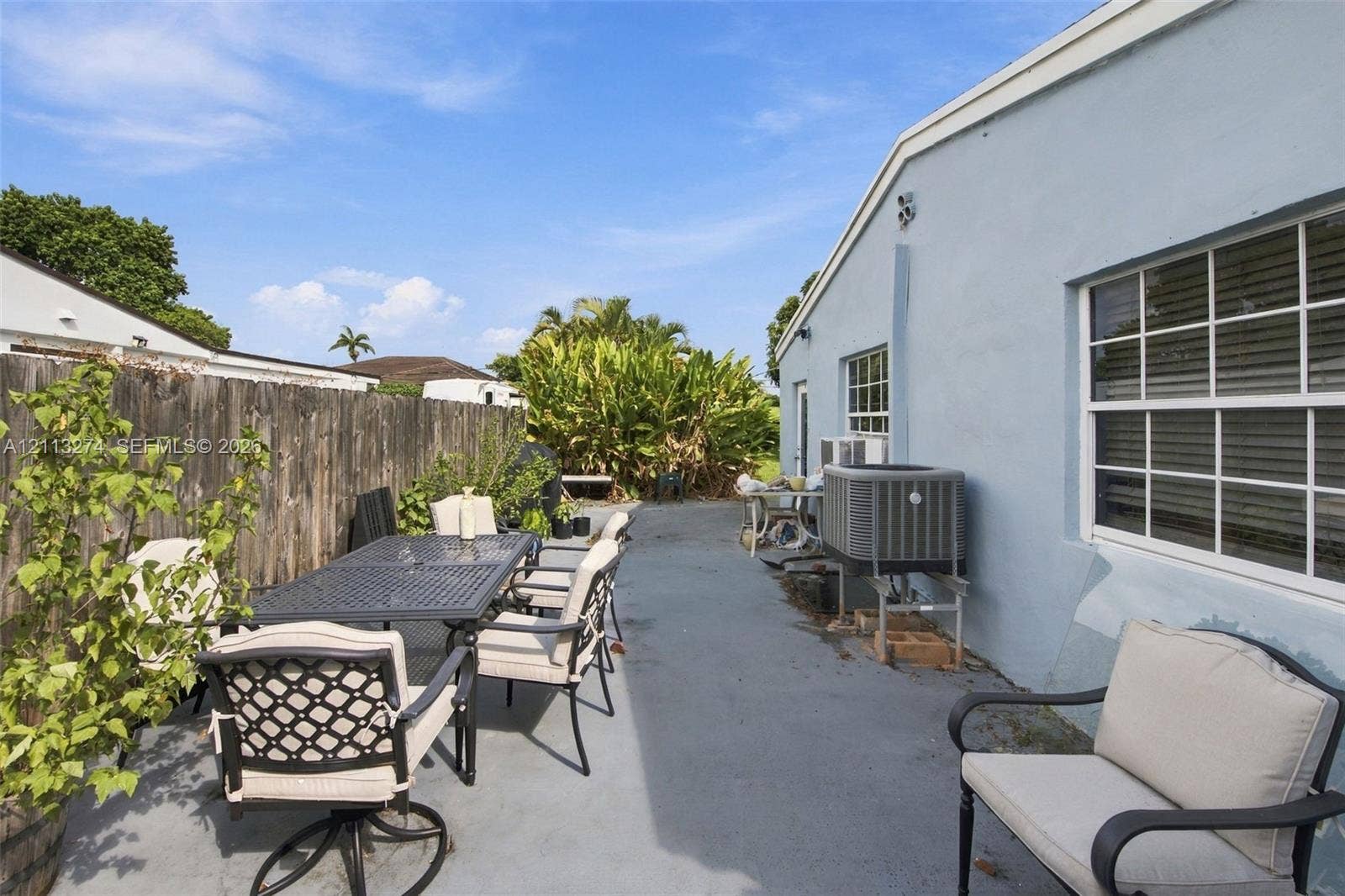 6521 SW 42nd Street, Miami, FL 33155 Concrete patio area featuring a wood-panel fence and exterior siding