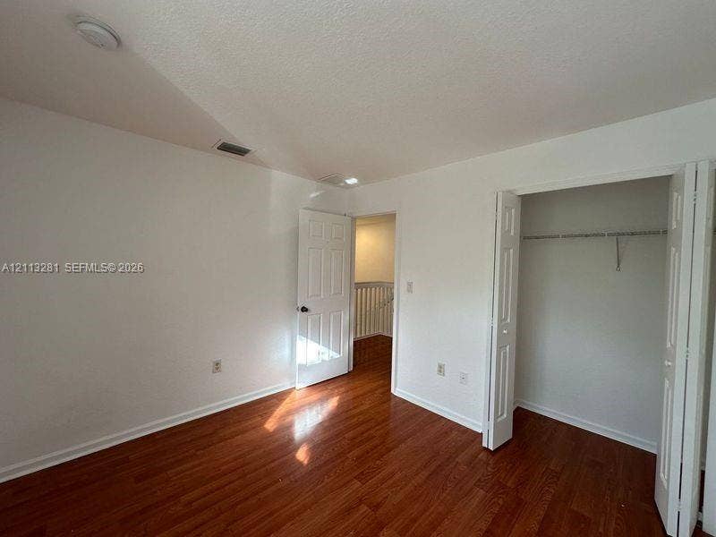 2615 SE 15th Place, #190, Homestead, FL 33035 Wood-finish flooring, six-panel interior doors, and closet with built-in metal shelving