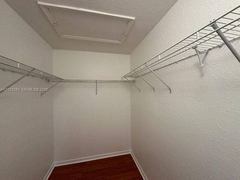 2615 SE 15th Place, #190, Homestead, FL 33035 Walk-in closet featuring white walls, wood-finish flooring, and tiered wire shelving