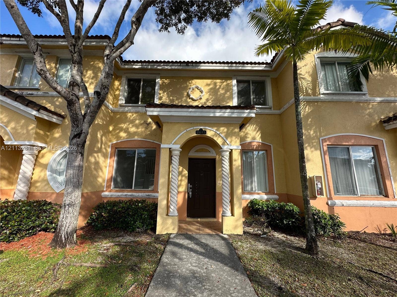 2615 SE 15th Place, #190, Homestead, FL 33035 Two-story exterior featuring stucco siding, spiral columns at the entryway, decorative arch window detailing, and a tile roof