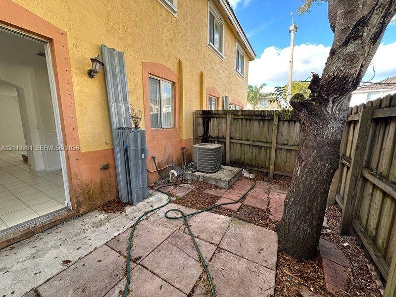 2615 SE 15th Place, #190, Homestead, FL 33035 Stucco exterior featuring dual-pane windows, a private concrete patio, and a wood privacy fence