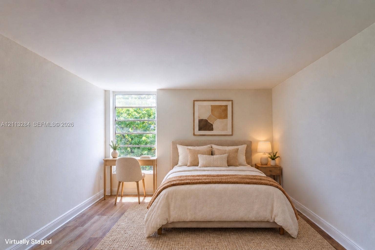 Room featuring neutral wall finishes and wood-finish flooring with a multi-pane window