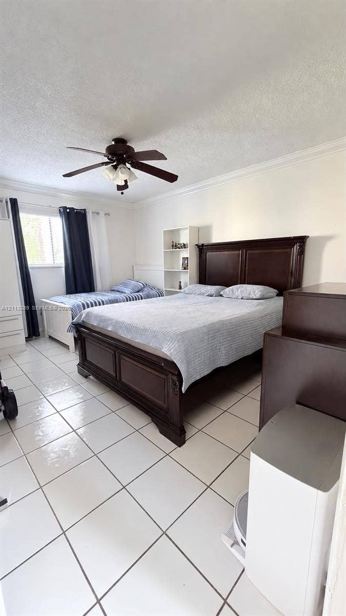 5460 W 21st Court, #208, Hialeah, FL 33016 Room featuring tile flooring, ceiling fan with integrated lighting, and crown molding