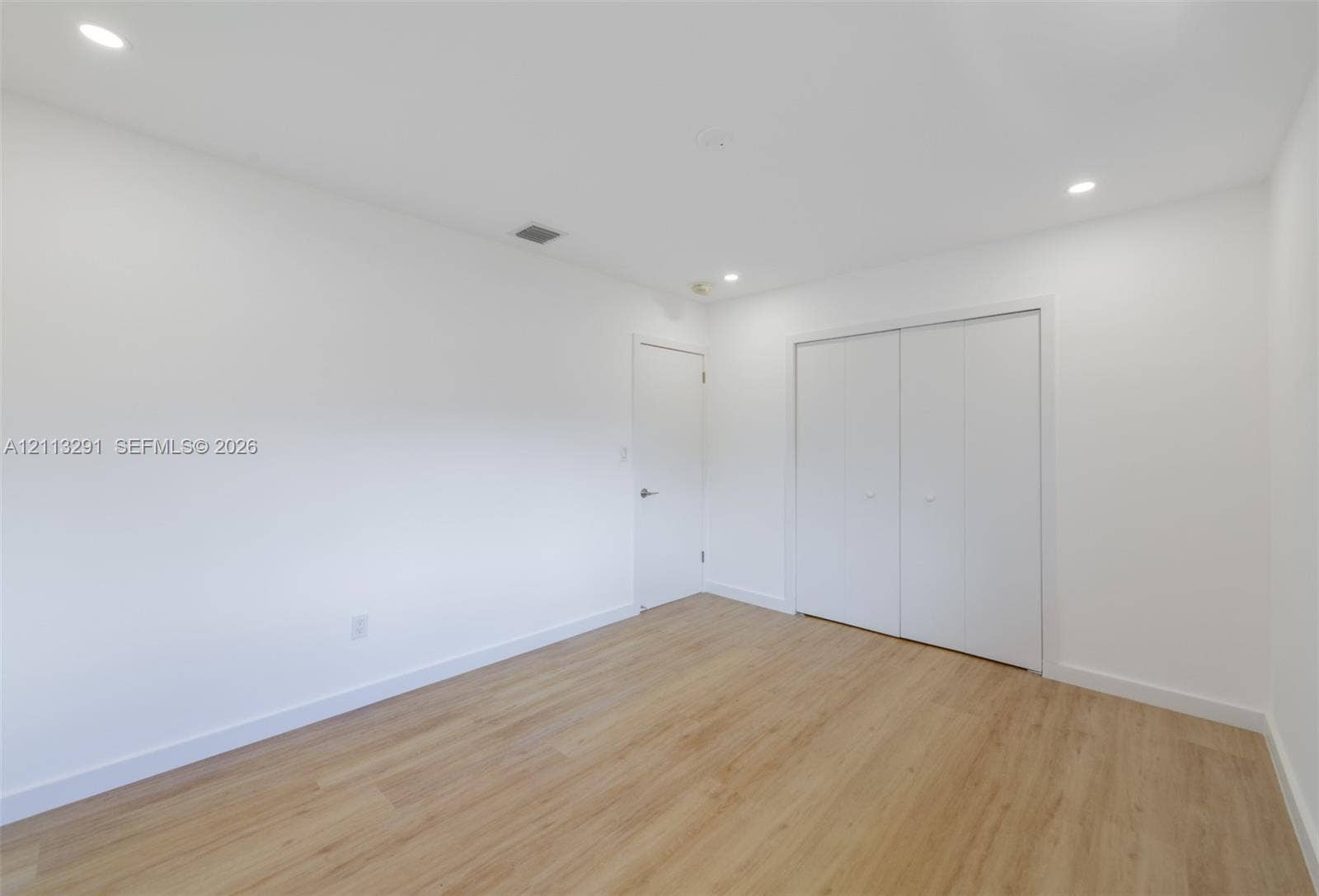 Interior room featuring wood-finish flooring, recessed lighting, and a double-door closet