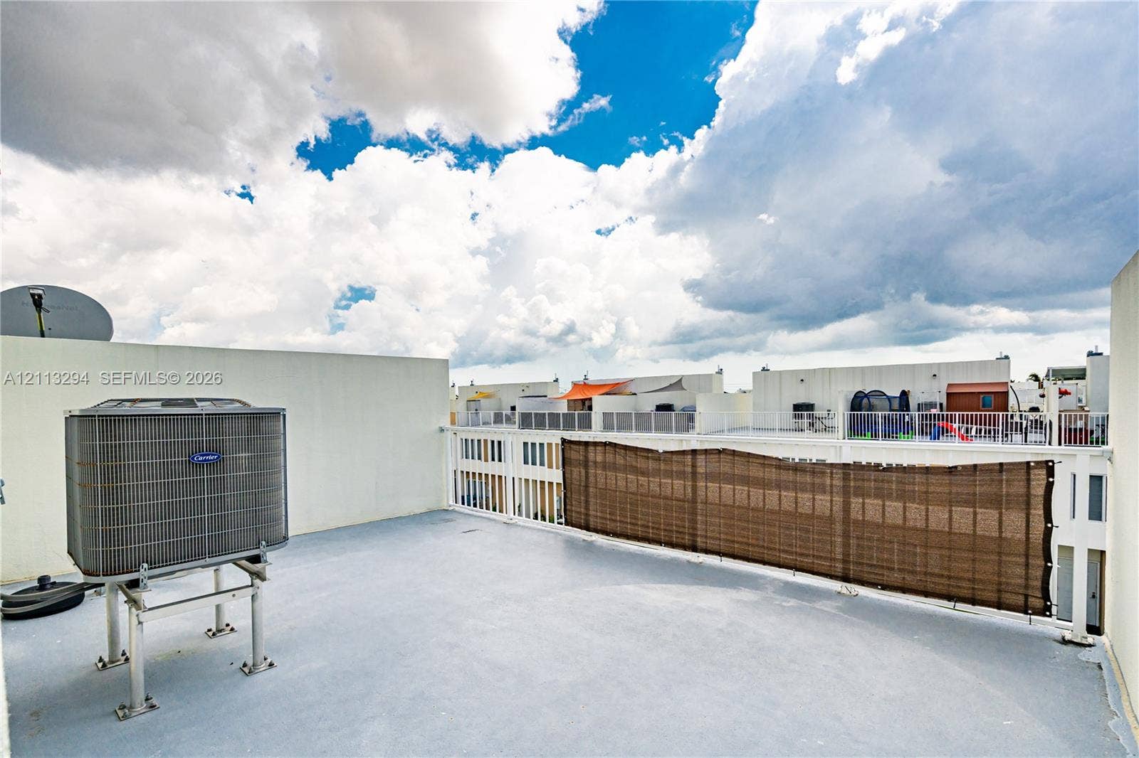 25880 SW 139th Path, #0, Homestead, FL 33032 Rooftop deck with solid wall perimeter, white metal railing, and high-capacity exterior HVAC unit