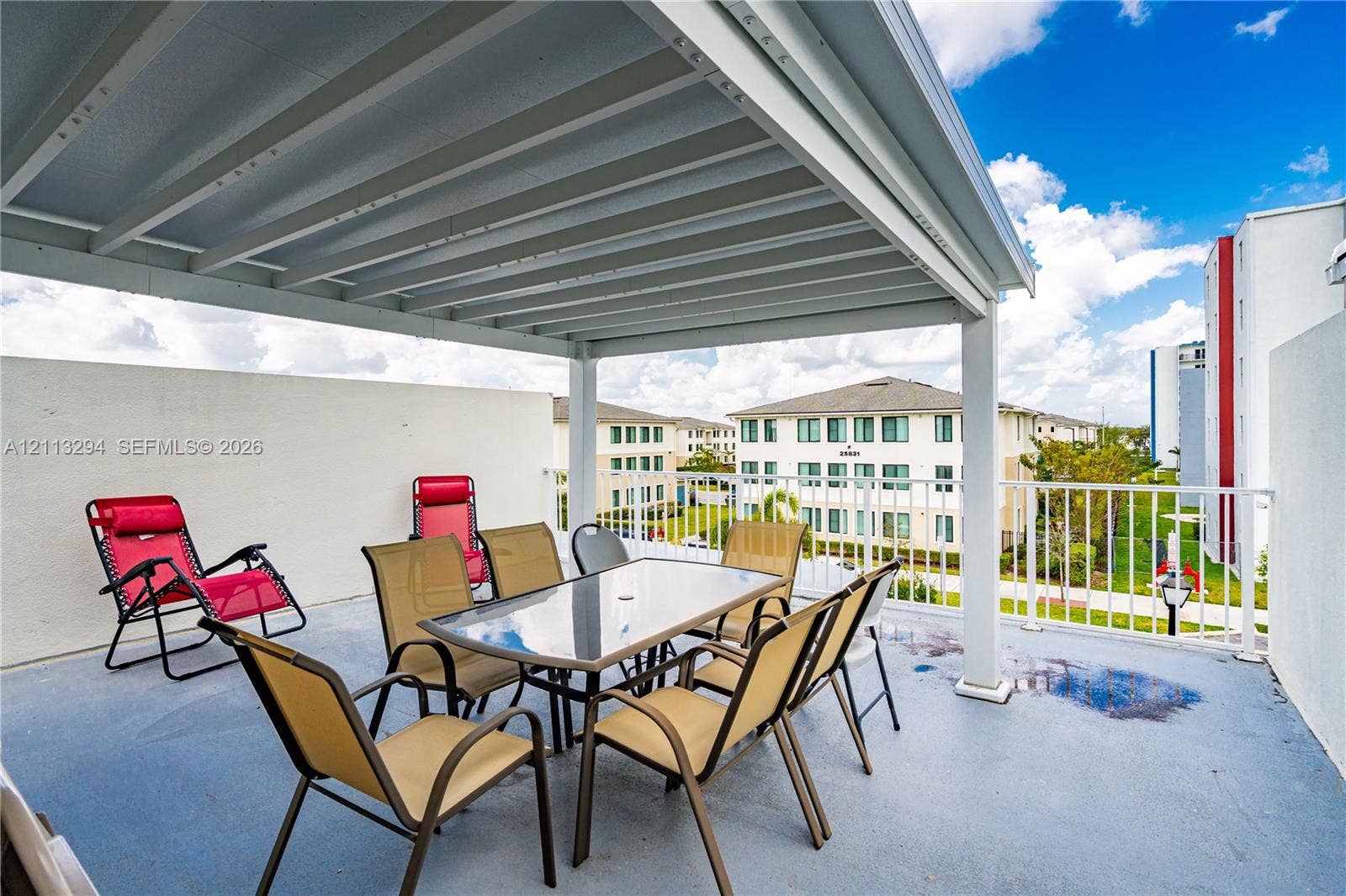 25880 SW 139th Path, #0, Homestead, FL 33032 Covered balcony featuring a white metal pergola, solid stucco side walls, and white metal railing