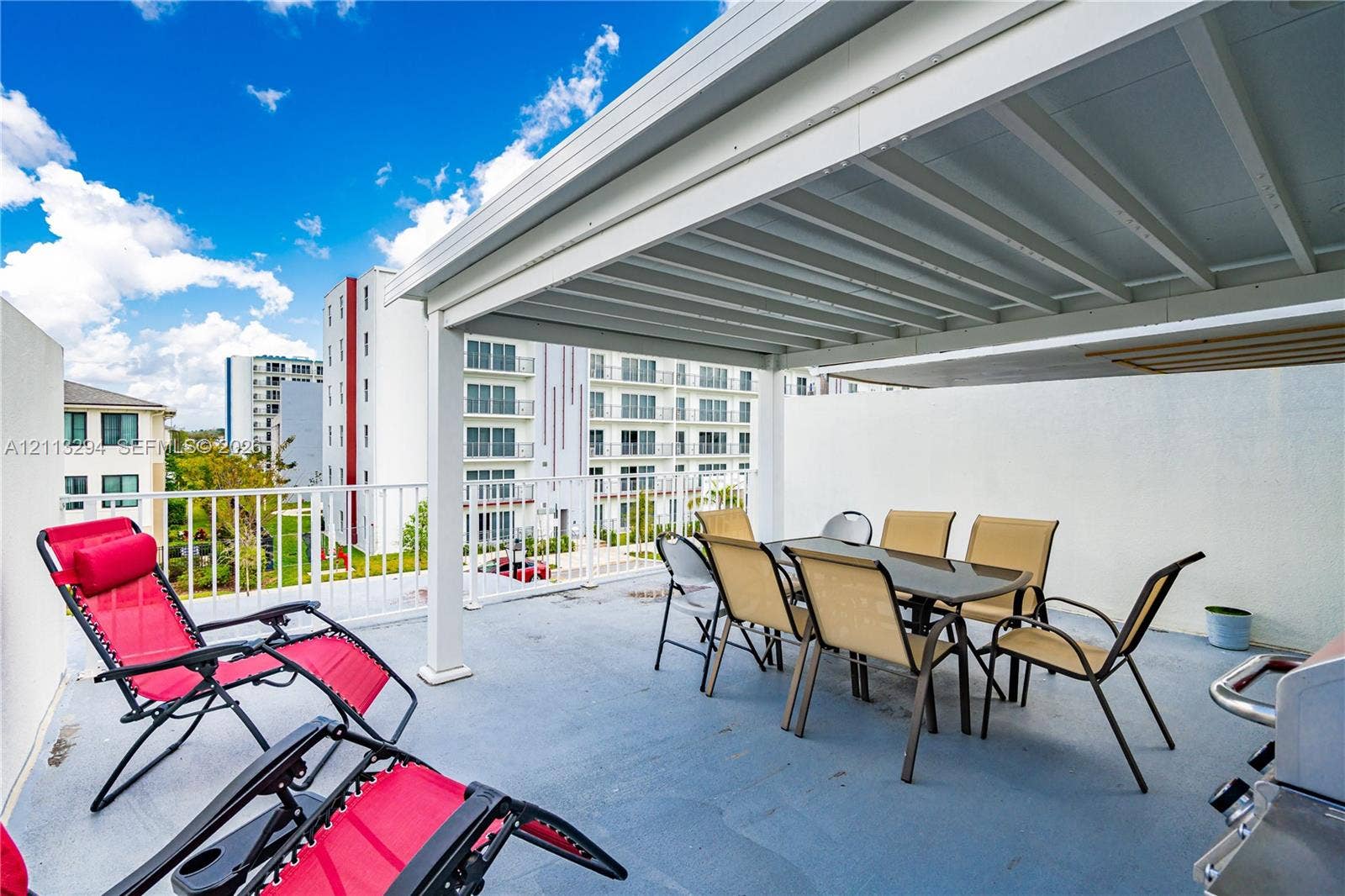 25880 SW 139th Path, #0, Homestead, FL 33032 Covered terrace featuring a flat-surface deck, white metal railings, and an integrated overhead canopy