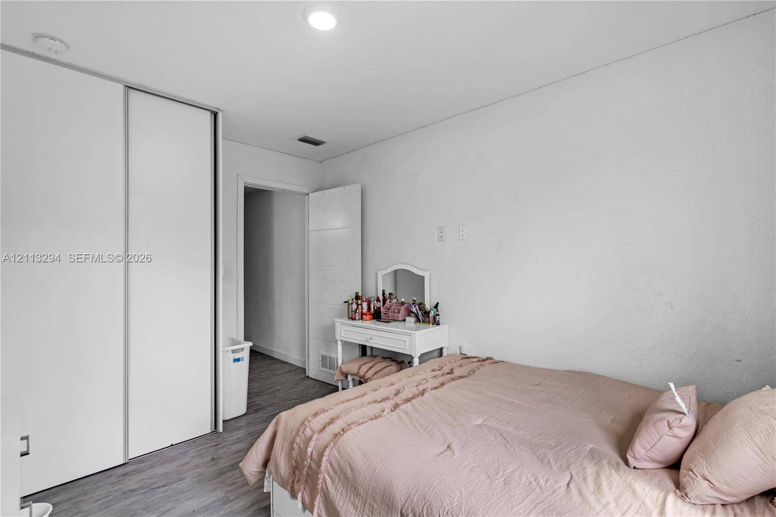 25880 SW 139th Path, #0, Homestead, FL 33032 Neutral-toned room featuring wood-finish flooring, recessed lighting, and a floor-to-ceiling sliding closet door
