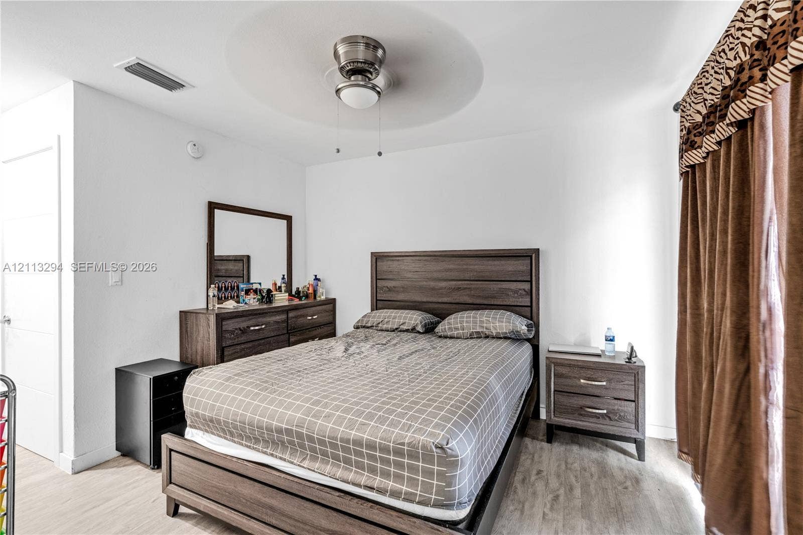 25880 SW 139th Path, #0, Homestead, FL 33032 Neutral-toned wall finish, wood-finish flooring, and a ceiling-mounted fan with integrated lighting