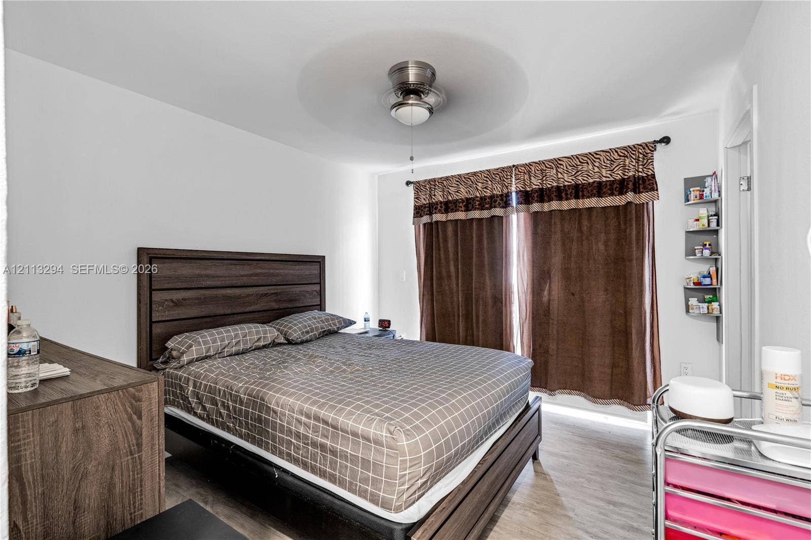 25880 SW 139th Path, #0, Homestead, FL 33032 Wood-finish flooring, brushed nickel ceiling fan with integrated lighting, and wall-mounted shelving