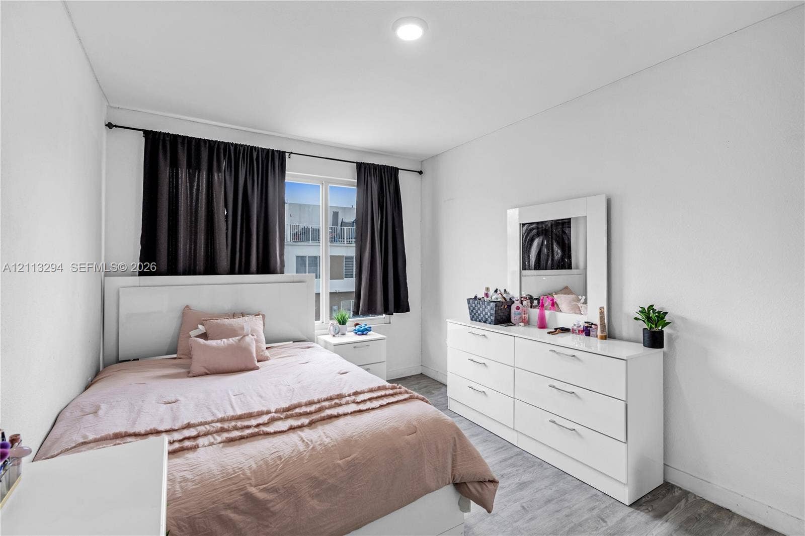 25880 SW 139th Path, #0, Homestead, FL 33032 Neutral-toned interior featuring wood-finish flooring, recessed lighting, and a single-pane window with a black curtain rod