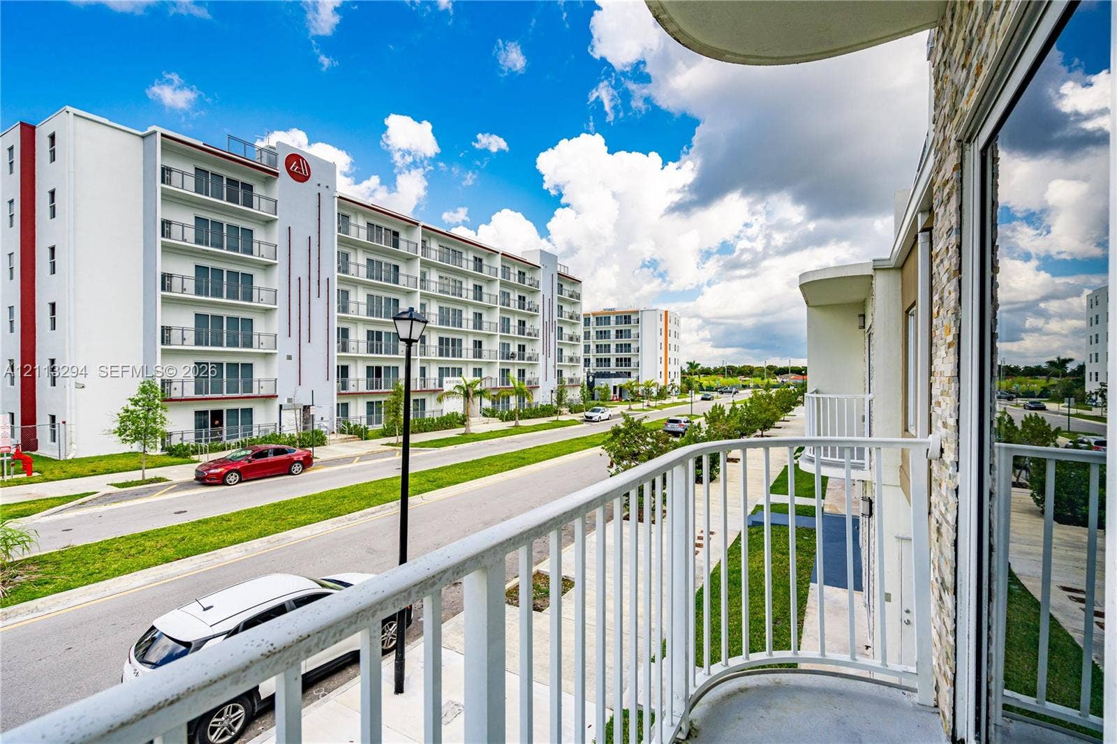 25880 SW 139th Path, #0, Homestead, FL 33032 Private balcony featuring curved white metal railing and stone-veneer exterior wall