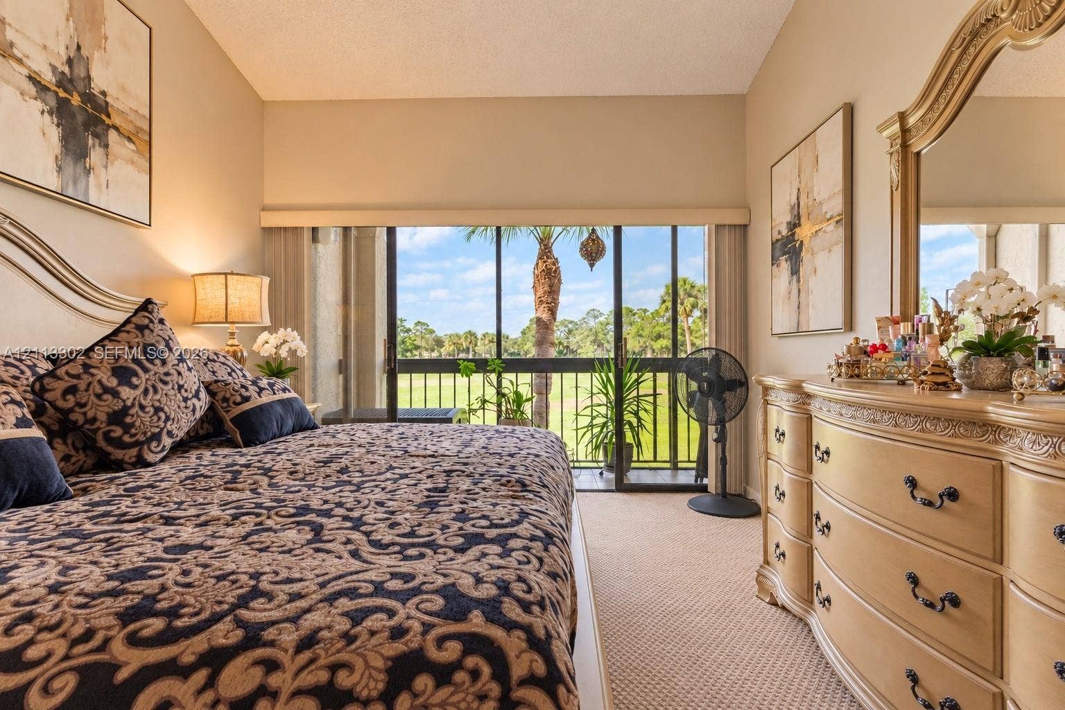 9450 Meadowood Drive, #202, Fort Pierce, FL 34951 Full-height sliding glass doors with black framing, wall-to-wall carpeting, and neutral paint palette