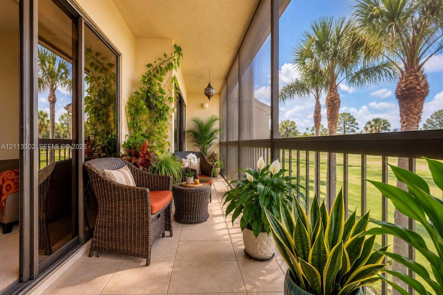 9450 Meadowood Drive, #202, Fort Pierce, FL 34951 Screened-in balcony featuring tile flooring, metal railings, and sliding glass door access