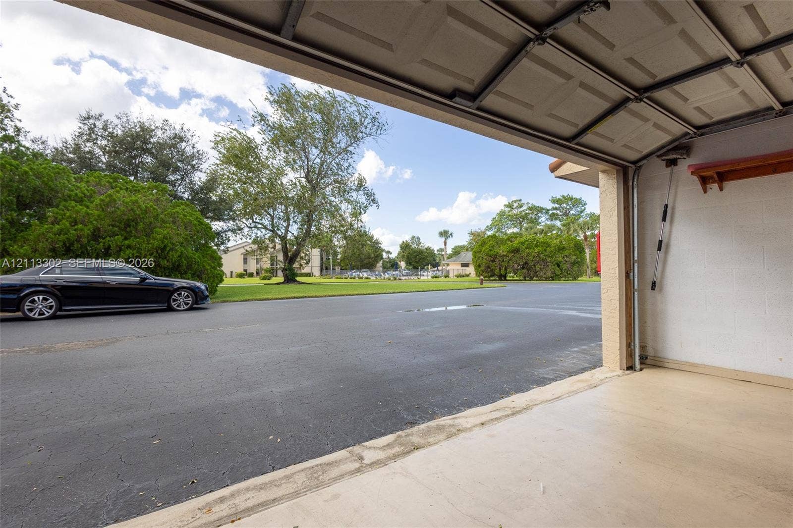 9450 Meadowood Drive, #202, Fort Pierce, FL 34951 Expansive grounds featuring manicured turf, sand bunkers, mature trees, and native palm trees