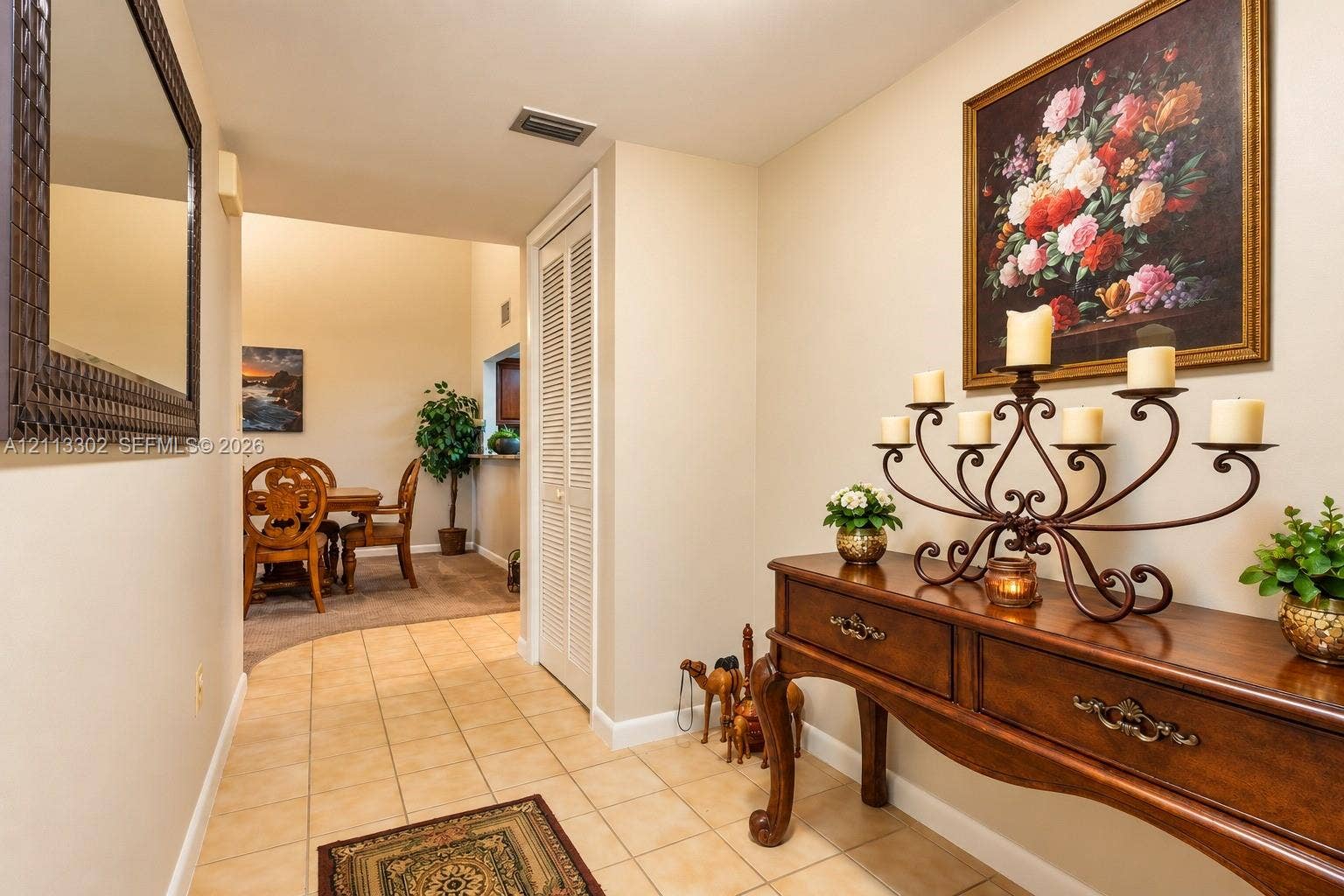 9450 Meadowood Drive, #202, Fort Pierce, FL 34951 Entryway featuring ceramic tile flooring, neutral wall color, and a full-height closet with louvered doors