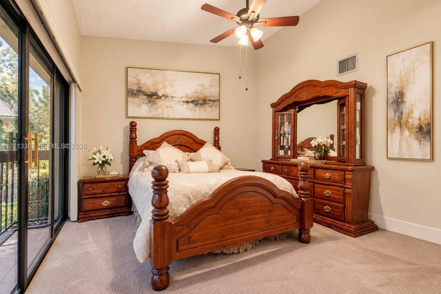 9450 Meadowood Drive, #202, Fort Pierce, FL 34951 Neutral-toned room featuring a ceiling fan with integrated lighting and sliding glass doors