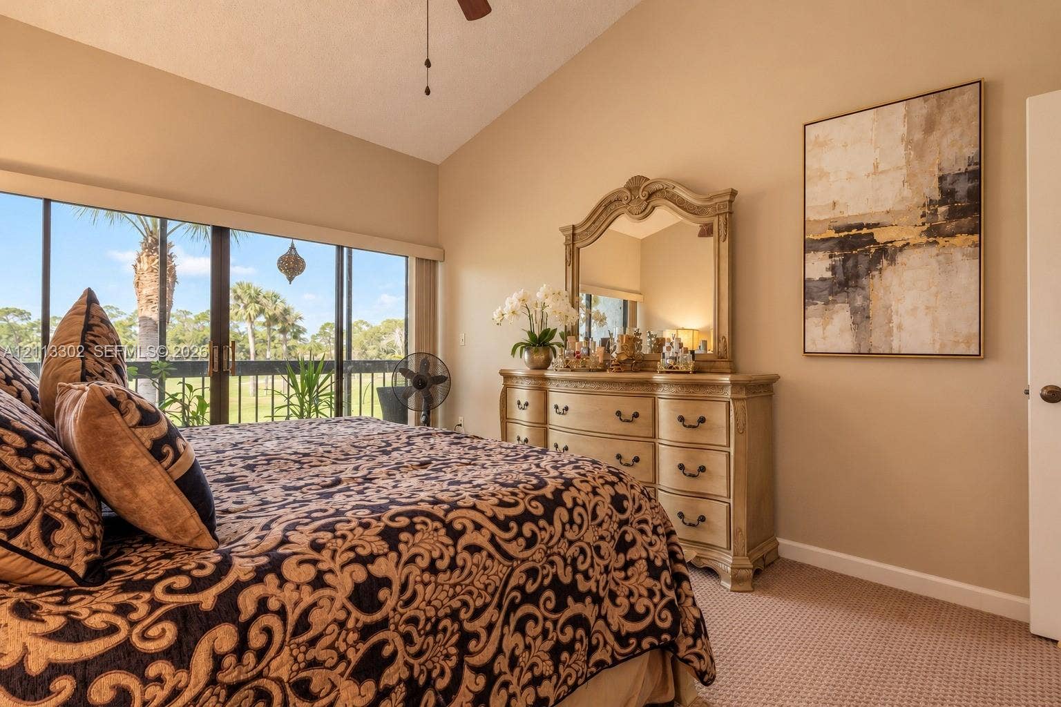 9450 Meadowood Drive, #202, Fort Pierce, FL 34951 Vaulted ceiling, wall-to-wall carpeting, and sliding glass doors with exterior screen enclosure
