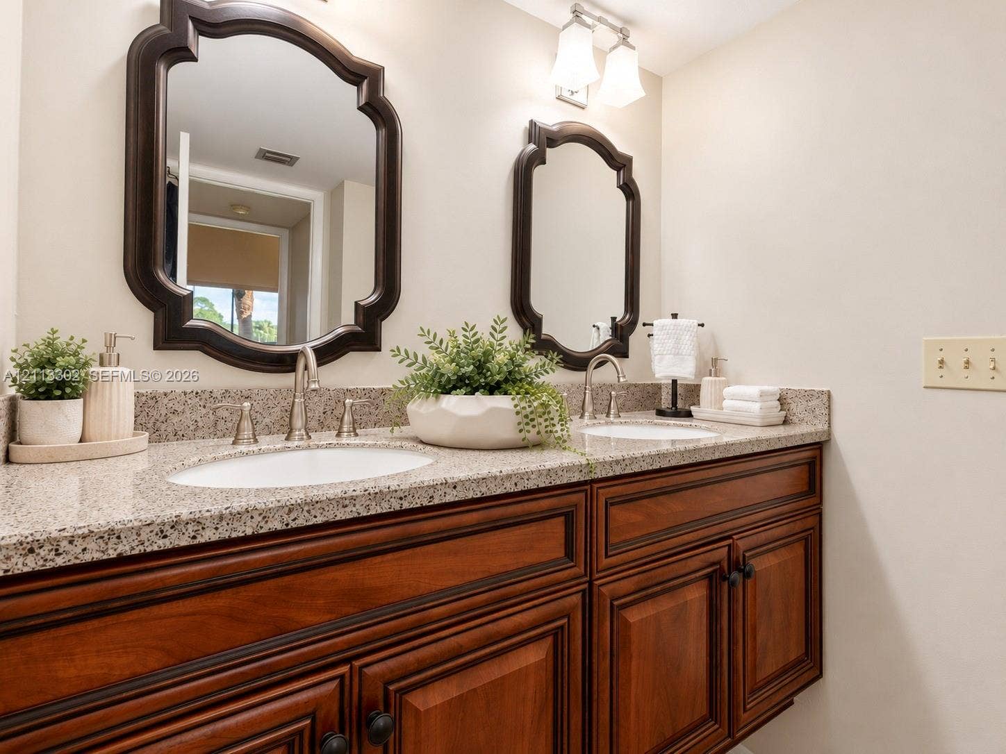 9450 Meadowood Drive, #202, Fort Pierce, FL 34951 Primary Bathroom Dual-vanity cabinet stone countertop