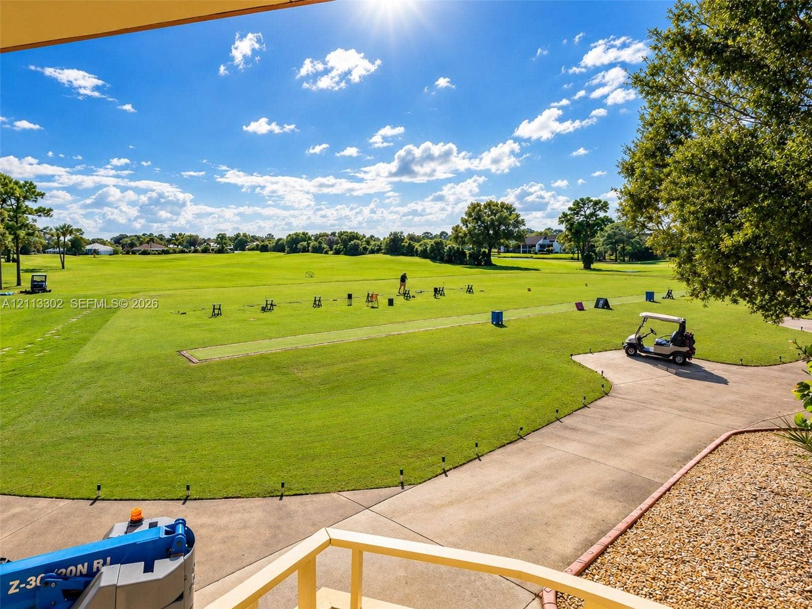 9450 Meadowood Drive, #202, Fort Pierce, FL 34951 Expansive golf course grounds featuring manicured turf, mature trees, and a paved cart path
