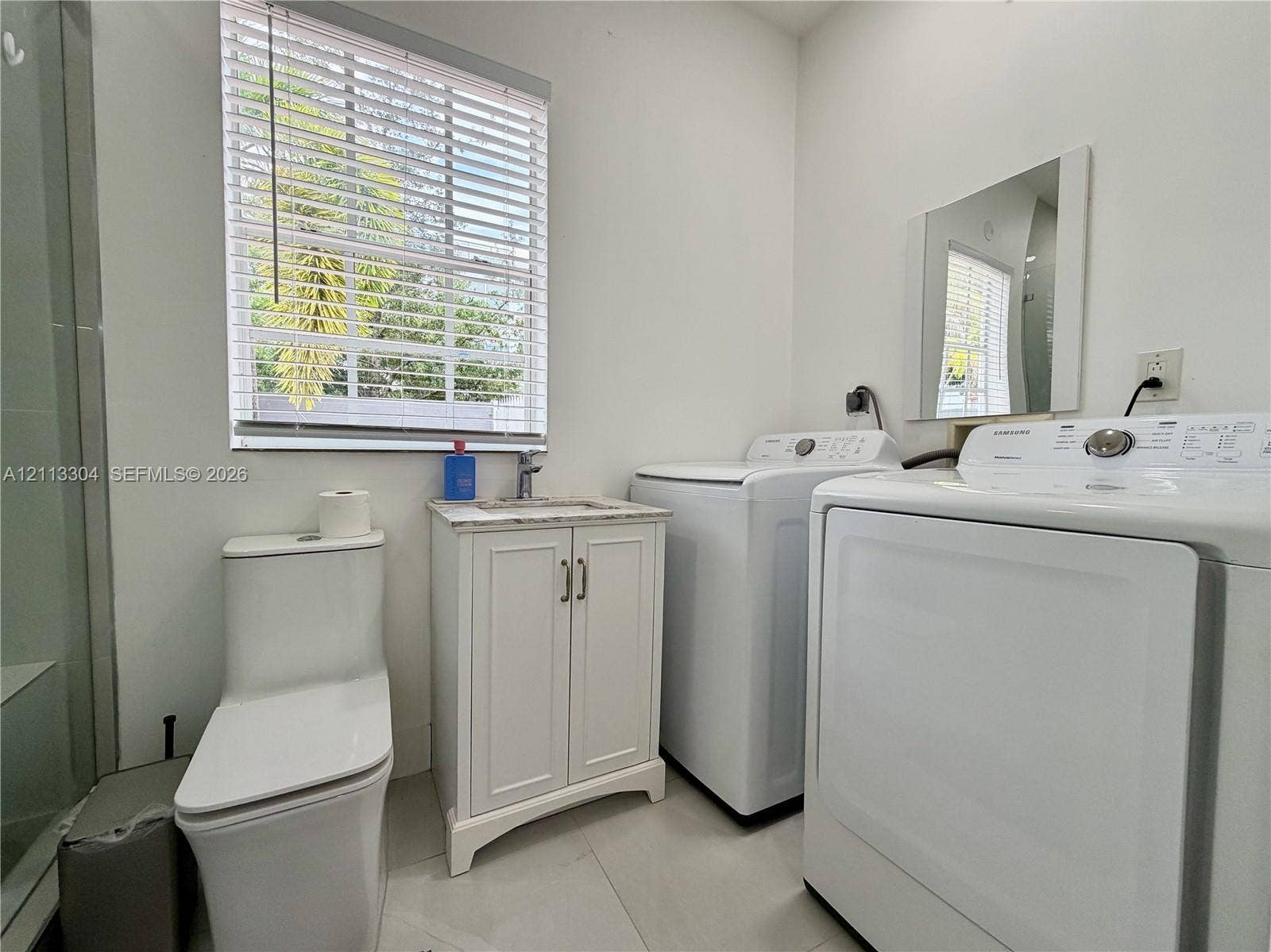 1810 SW 5th Avenue, #n/a, Miami, Miami, FL 33129 Bathroom featuring a floor-mounted toilet, vanity with a stone-finish countertop and integrated sink, wall-mounted mirror, and tile flooring