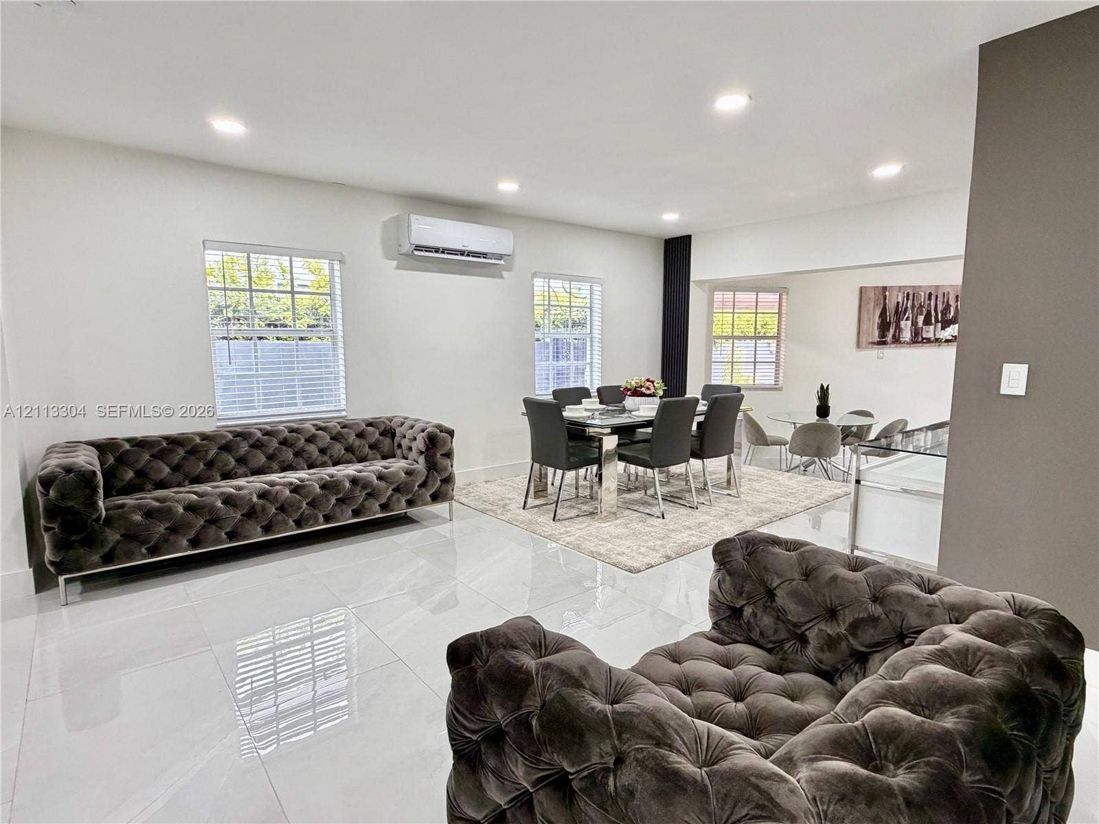 1810 SW 5th Avenue, #n/a, Miami, Miami, FL 33129 Large-format tile flooring, recessed ceiling lighting, wall-mounted ductless air conditioning unit, and multiple windows with white blinds