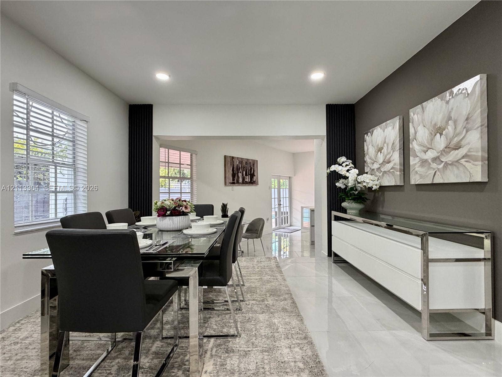1810 SW 5th Avenue, #n/a, Miami, Miami, FL 33129 Dining area featuring polished tile flooring, recessed lighting, and a distinct charcoal-toned accent wall