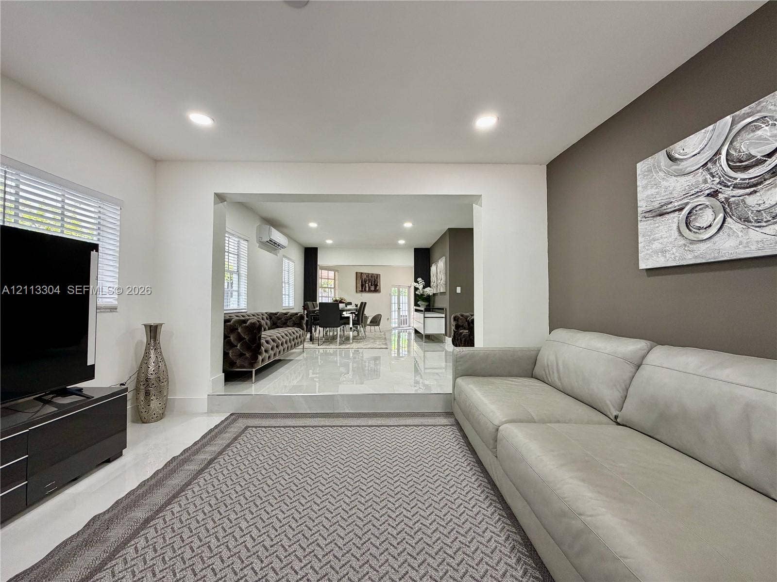 1810 SW 5th Avenue, #n/a, Miami, Miami, FL 33129 Sunken living area featuring large-format tile flooring, recessed lighting, and a prominent accent wall