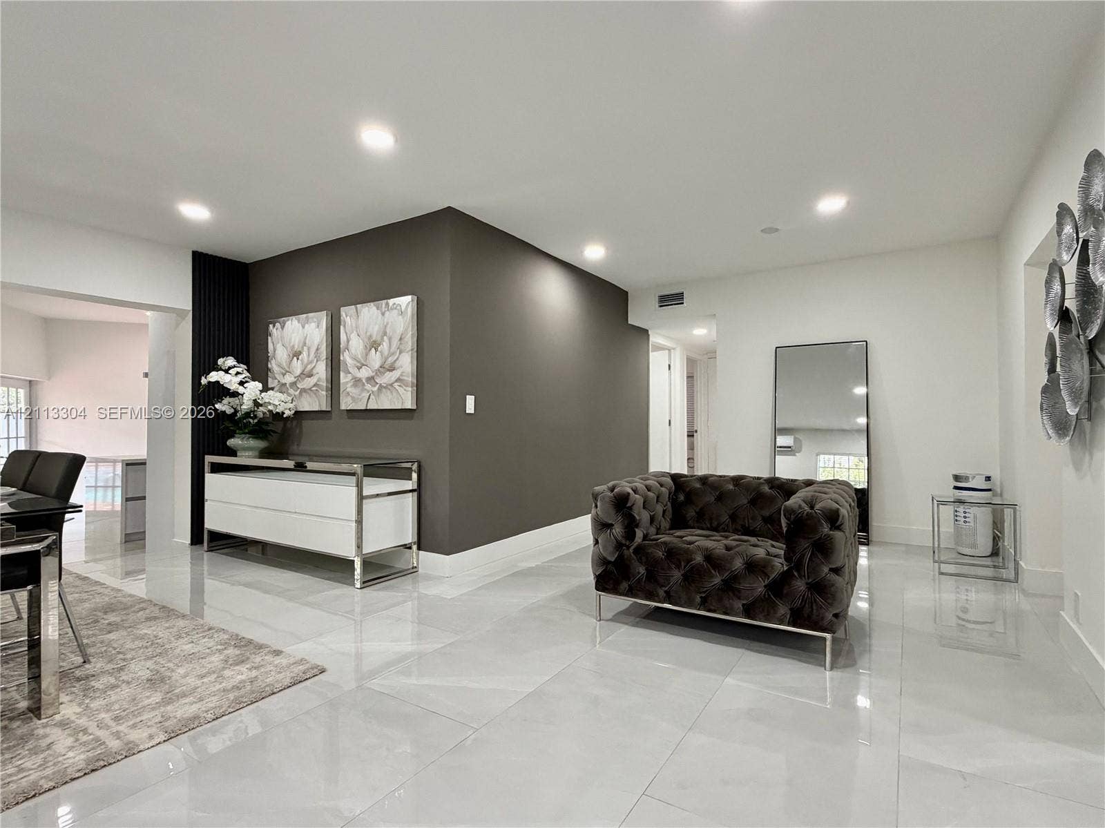 1810 SW 5th Avenue, #n/a, Miami, Miami, FL 33129 Large-format tile flooring, recessed ceiling lighting, and a dark accent wall featuring vertical slat detailing