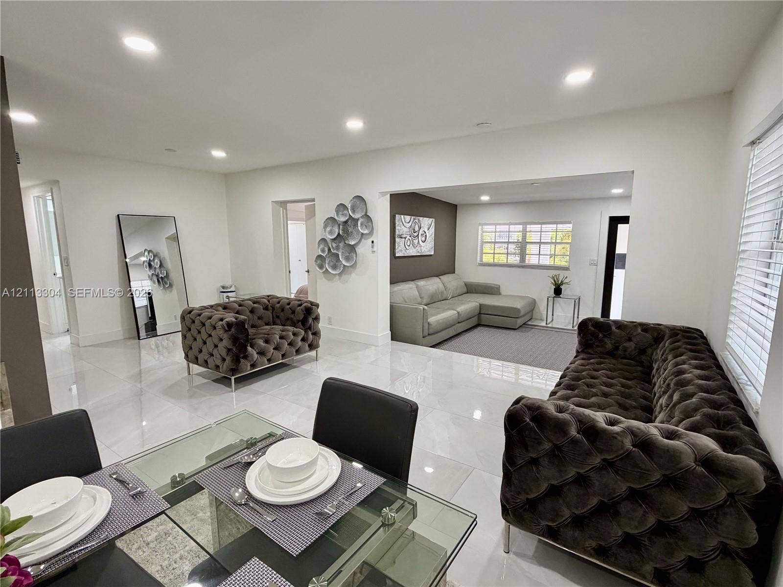 1810 SW 5th Avenue, #n/a, Miami, Miami, FL 33129 Open-concept interior featuring large-format polished tile flooring, recessed ceiling lighting, and a multi-pane window with white window blinds