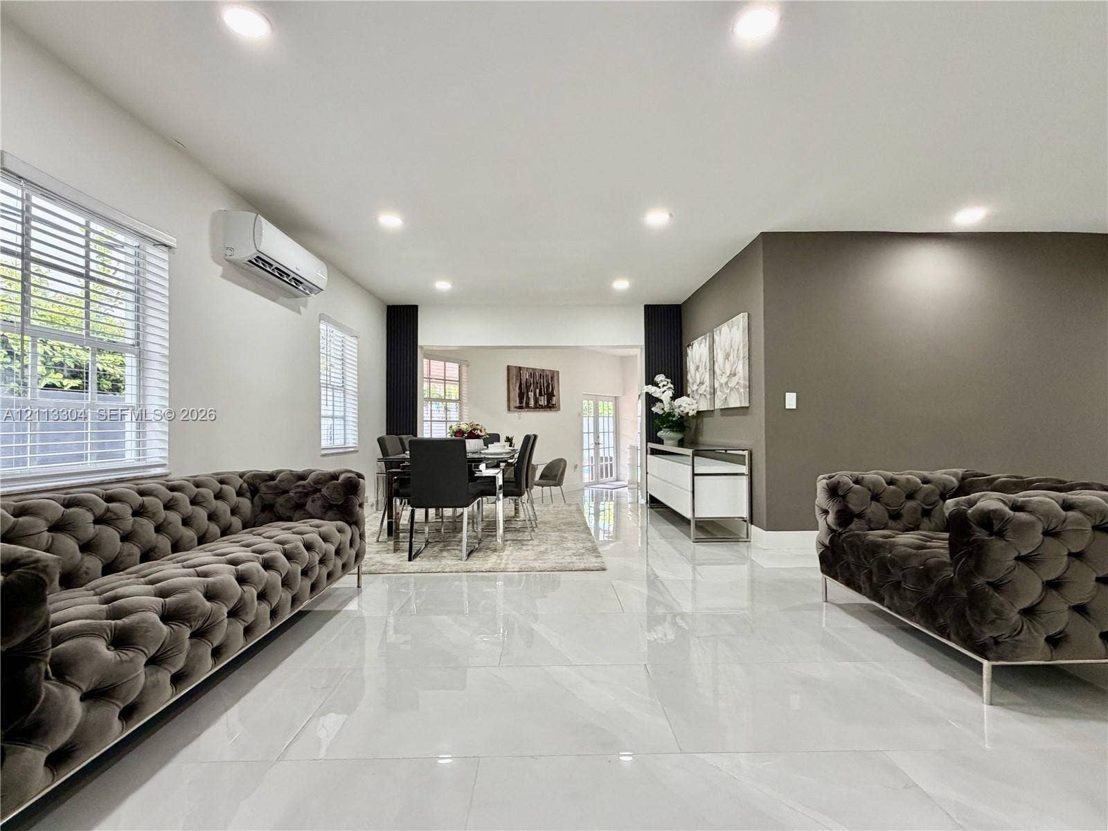 1810 SW 5th Avenue, #n/a, Miami, Miami, FL 33129 Large-format polished tile flooring, wall-mounted ductless climate control unit, recessed lighting, and accent wall featuring a neutral color palette