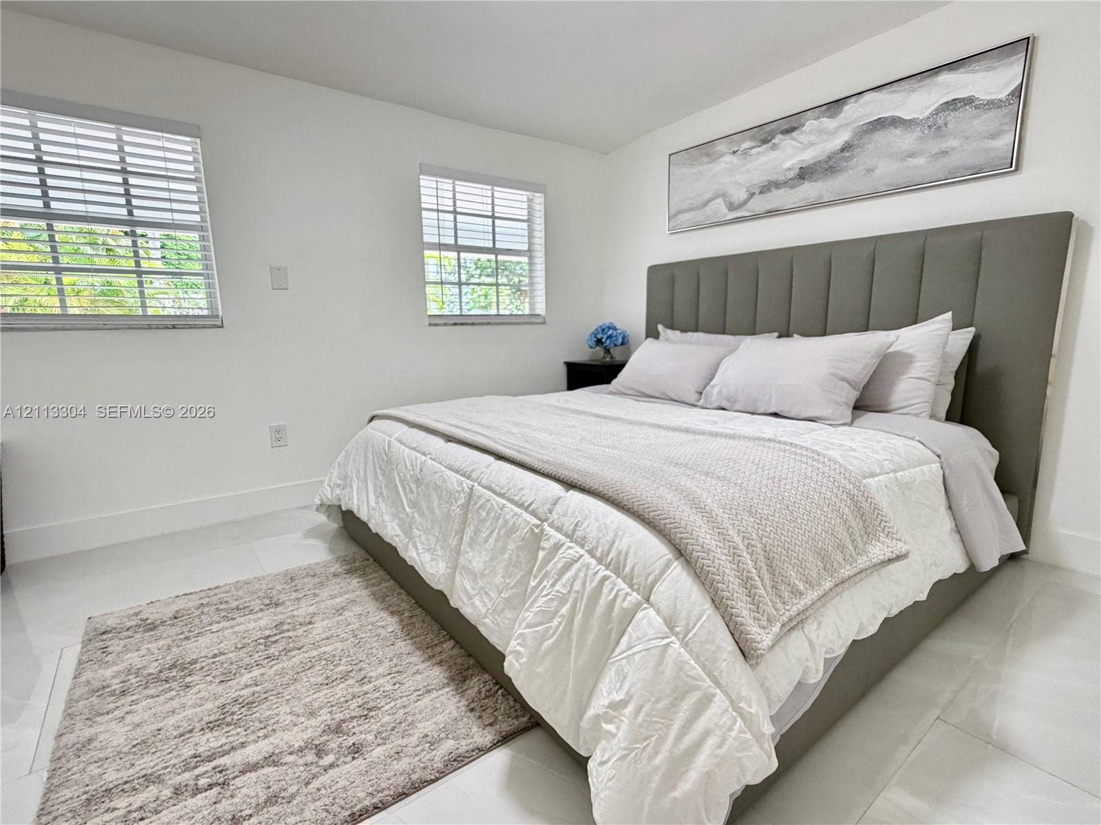 1810 SW 5th Avenue, #n/a, Miami, Miami, FL 33129 Neutral-toned interior featuring large-format tile flooring and two windows with adjustable horizontal blinds