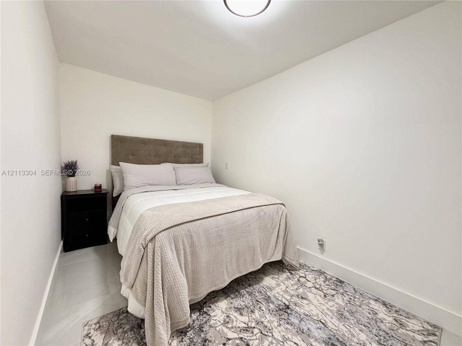 1810 SW 5th Avenue, #n/a, Miami, Miami, FL 33129 Room featuring neutral-toned walls, light-colored tile flooring, and a flush-mount ceiling light fixture