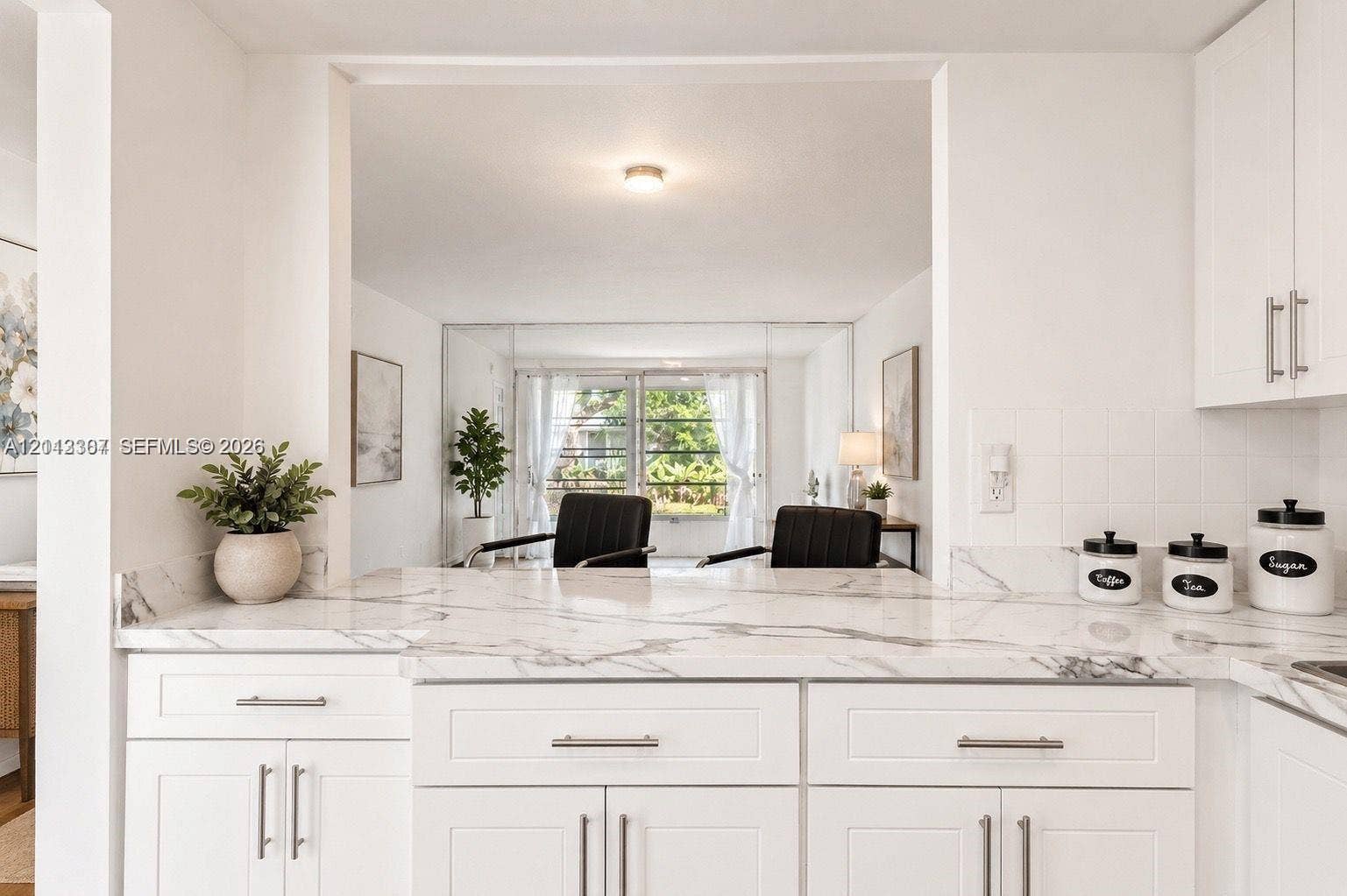 7605 NW 5th Place, #103, Margate, Margate, FL 33063 Kitchen featuring white shaker-style cabinetry, stone-patterned countertops, and tile backsplash