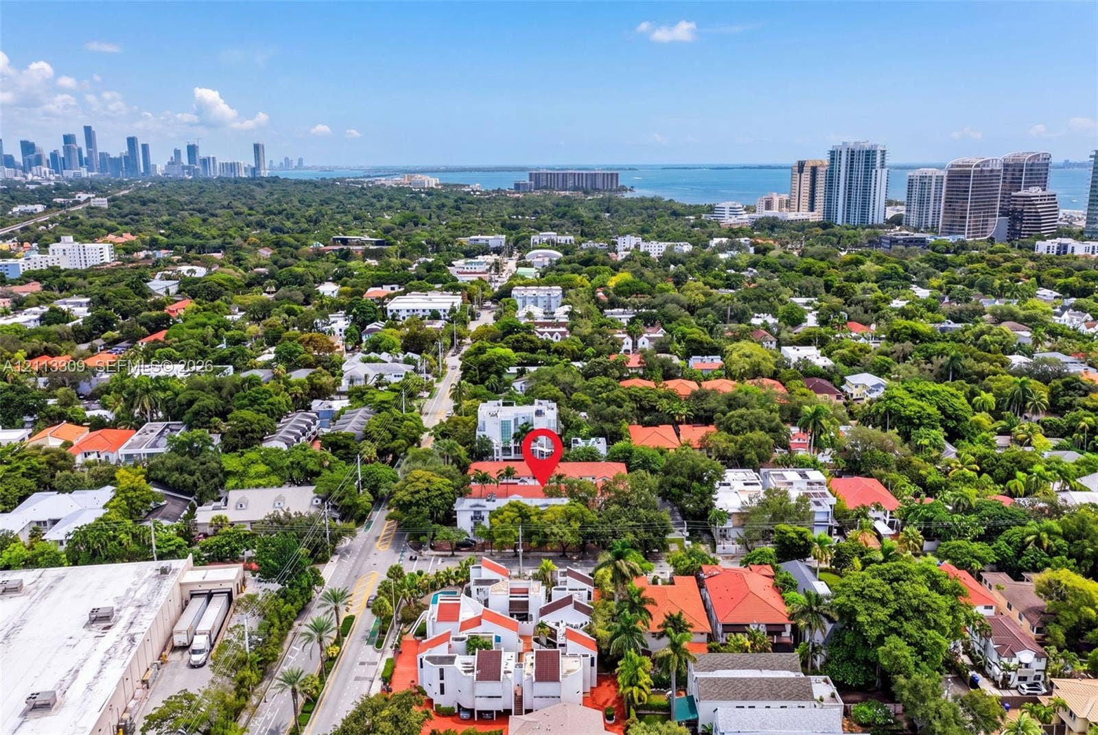 3082 Bird Avenue, #6, Miami, FL 33133 Aerial perspective of the property featuring a dense canopy of mature trees and proximity to the coastline and urban skyline