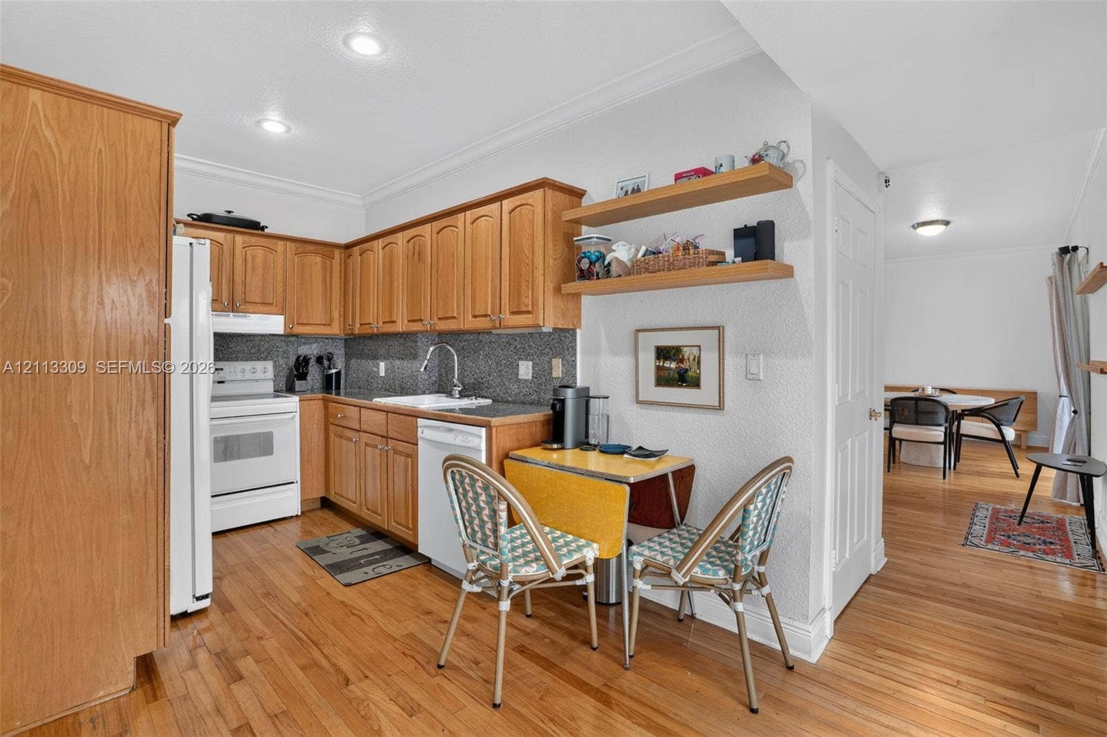 3082 Bird Avenue, #6, Miami, FL 33133 Kitchen featuring wood cabinetry, natural wood-finish flooring, recessed lighting, stone-textured backsplash, and built-in open shelving