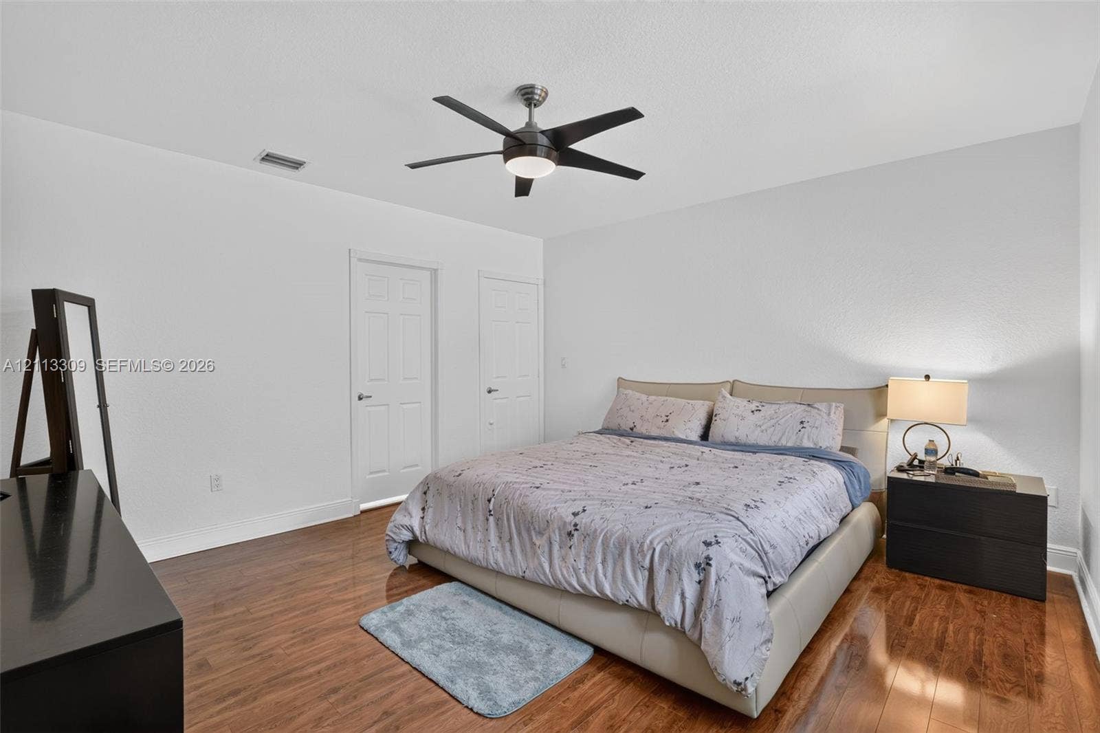 3082 Bird Avenue, #6, Miami, FL 33133 Neutral wall finish, wood-finish flooring, two paneled interior doors, and a ceiling-mounted fan with integrated lighting