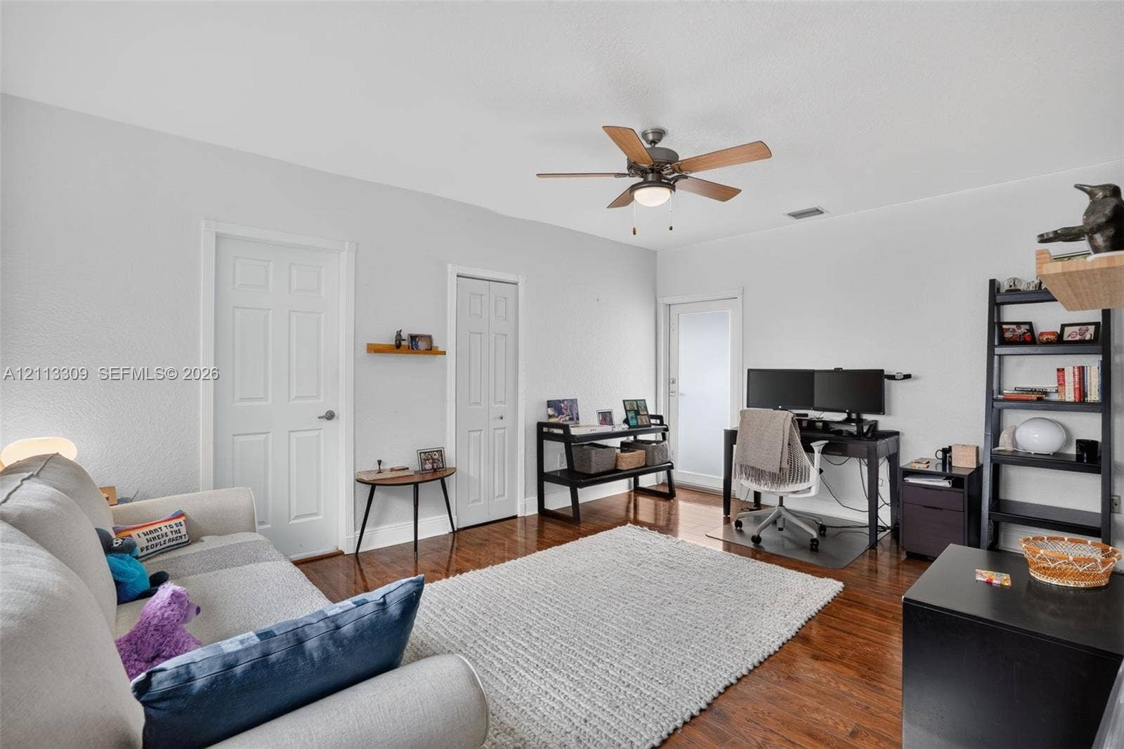 3082 Bird Avenue, #6, Miami, FL 33133 Room featuring wood-finish flooring, a ceiling fan with integrated lighting, and a glass-panel exterior door